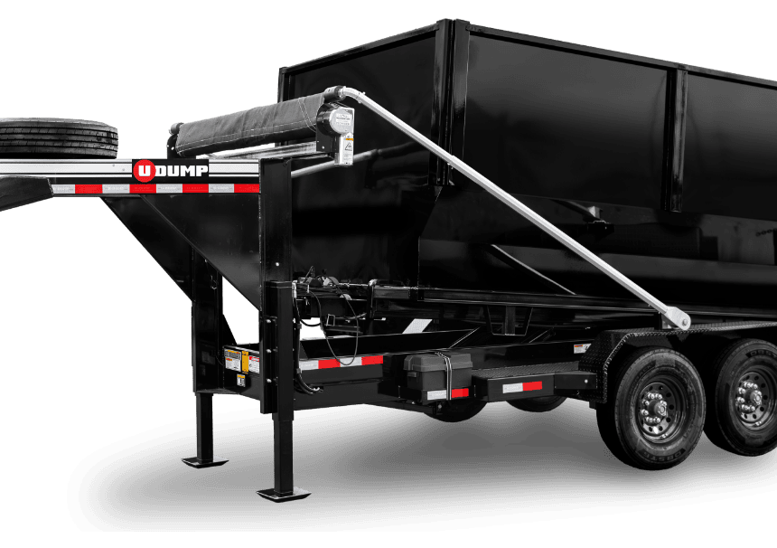 Black dump trailer with three axles, a spare tire mounted on the front, and hydraulic lift system.