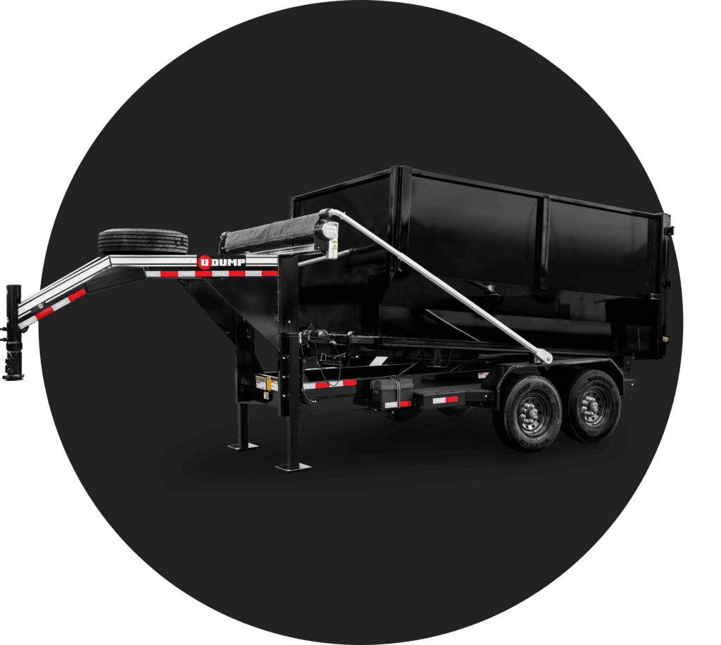 Black dump trailer with dual axles and a spare tire, positioned on a circular black background.