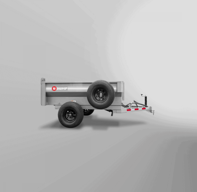 Small, gray Turf-Series Dump Trailer featuring two wheels, a hitch, and the WHIP logo on its side, set against a plain background.