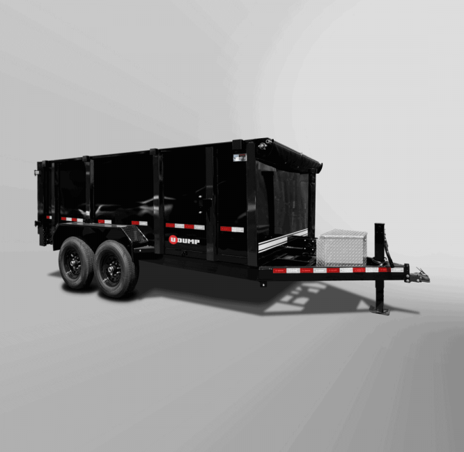 The Pro-Heavy Low-Profile Dump Trailer is a black dual-axle dump trailer, set against a gray background, with red and white reflectors and a front-mounted toolbox.